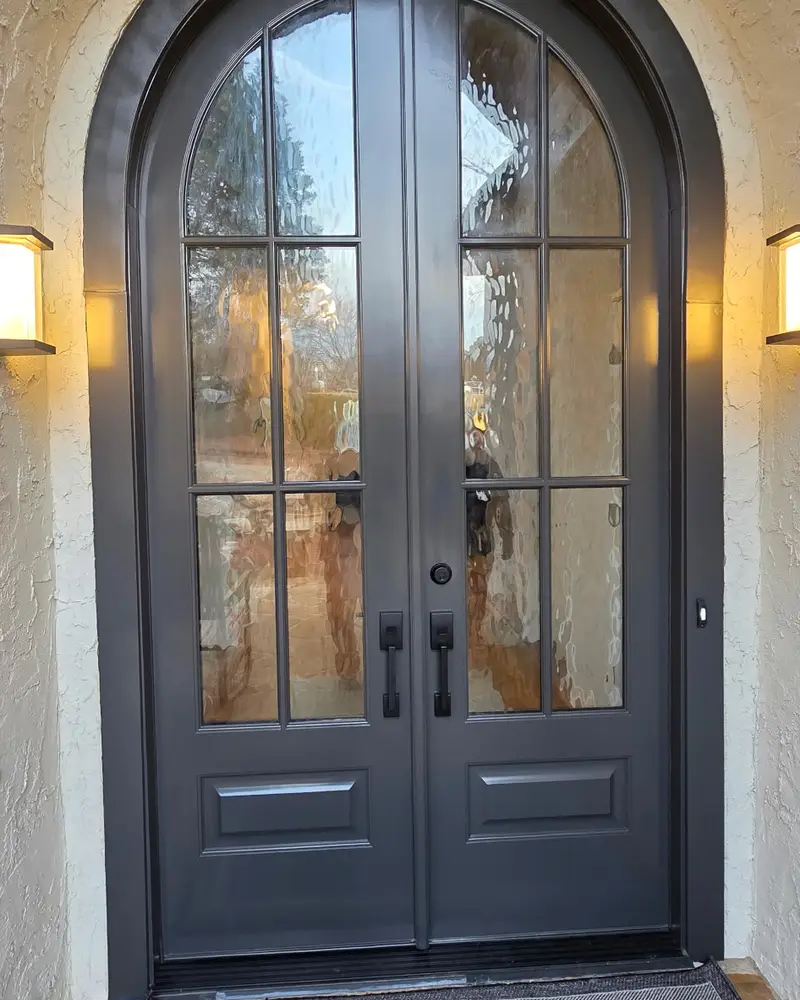 Arched double front doors with a dark finish, from a Wheeler Painting project