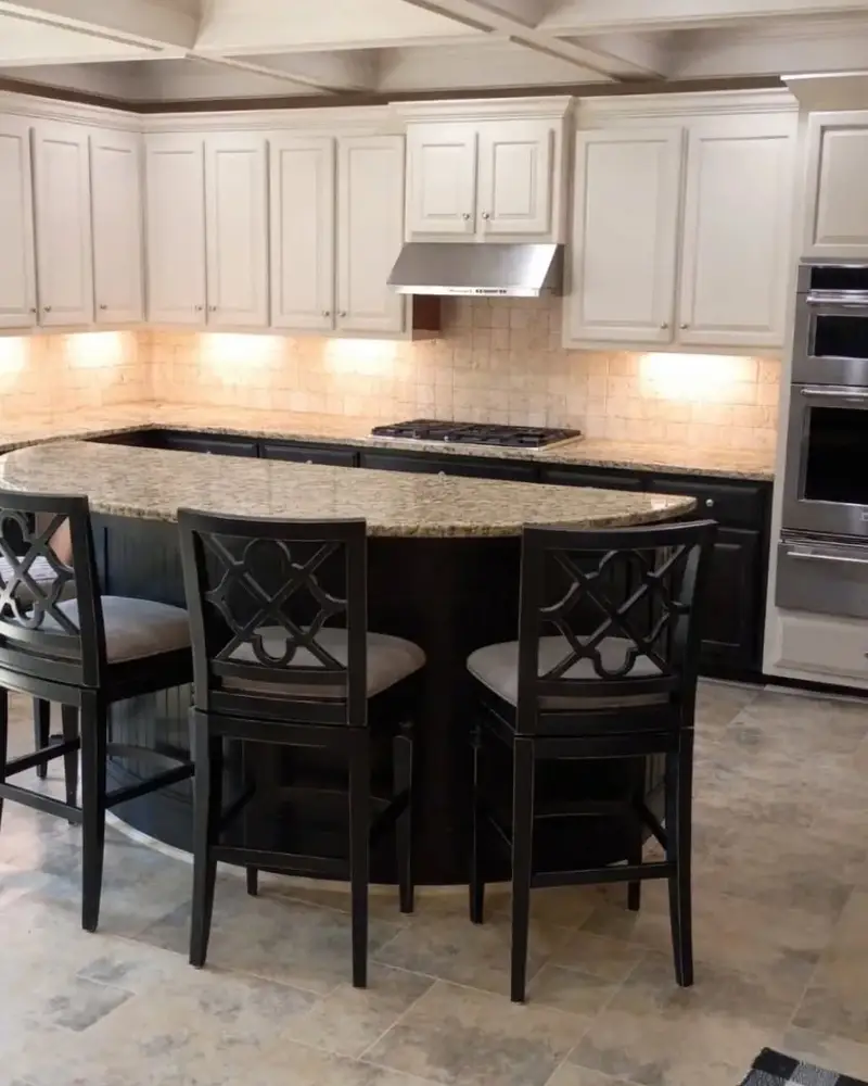 Kitchen with white perimeter cabinets and a dark island, from a Wheeler Painting cabinet project