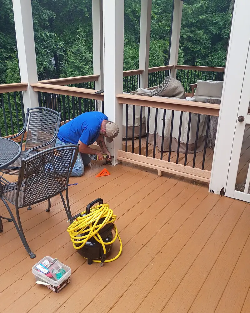 Wheeler Painting crew member staining a covered deck