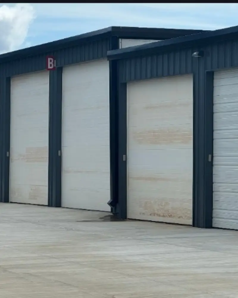 Before: weathered, stained commercial roll-up doors ahead of painting by Wheeler Painting