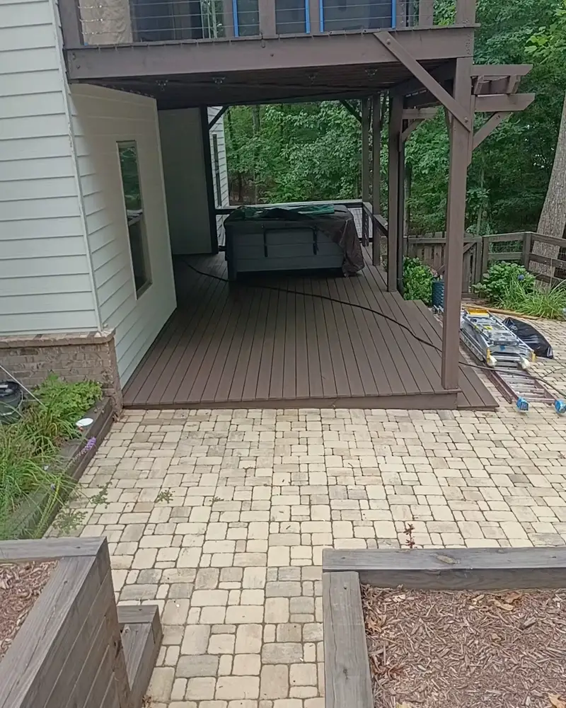 Covered patio with a stained wood ceiling and paver walk, from a Wheeler Painting exterior project