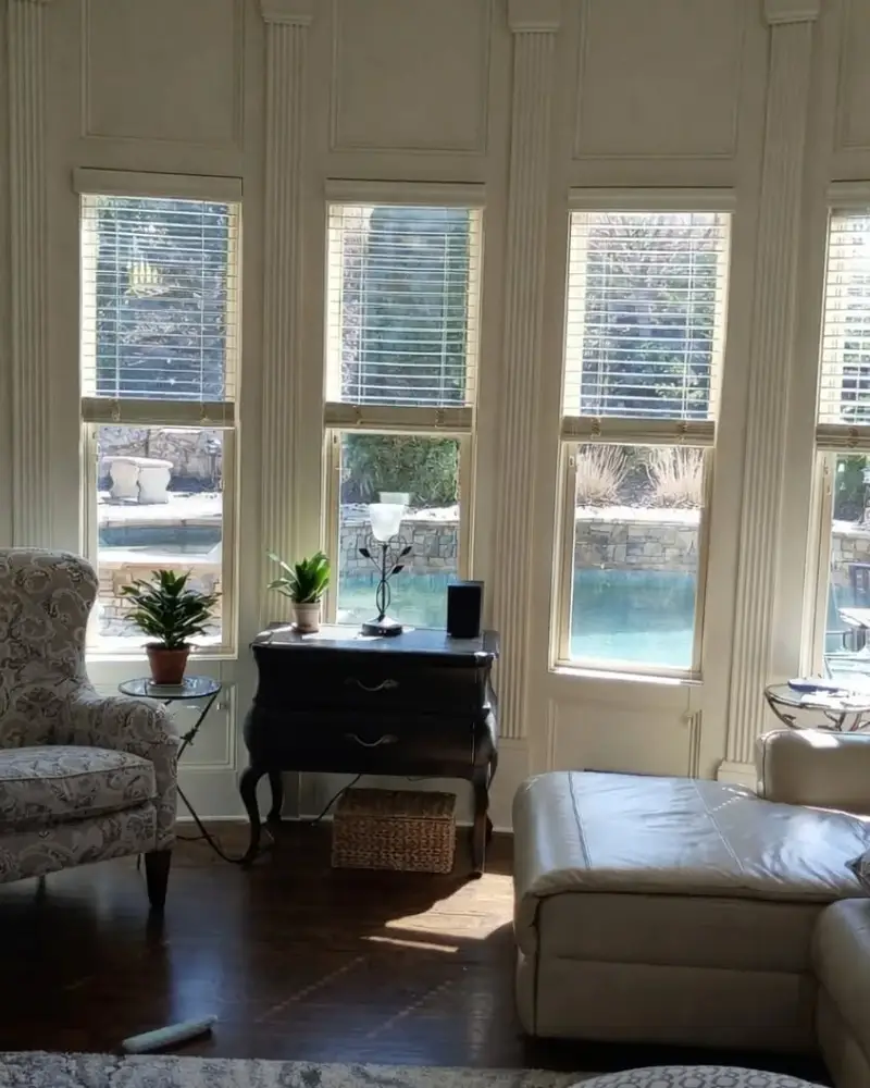 Living room with a wall of windows and fresh trim, from a Wheeler Painting interior repaint