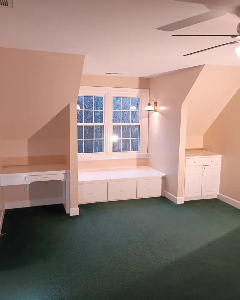 Finished bonus room with a painted window seat and built-ins, from a Wheeler Painting interior repaint