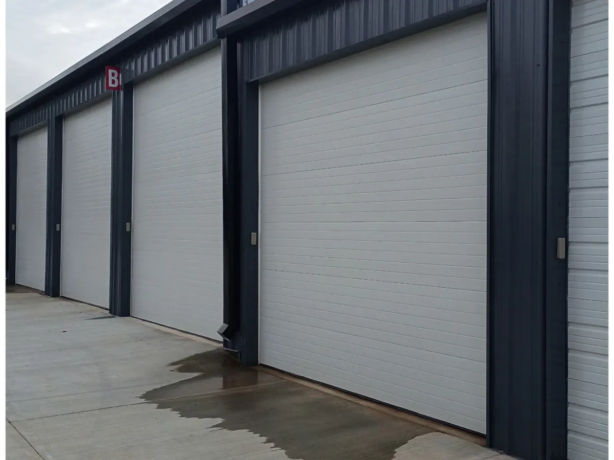 Freshly painted commercial storage roll-up doors and dark metal trim