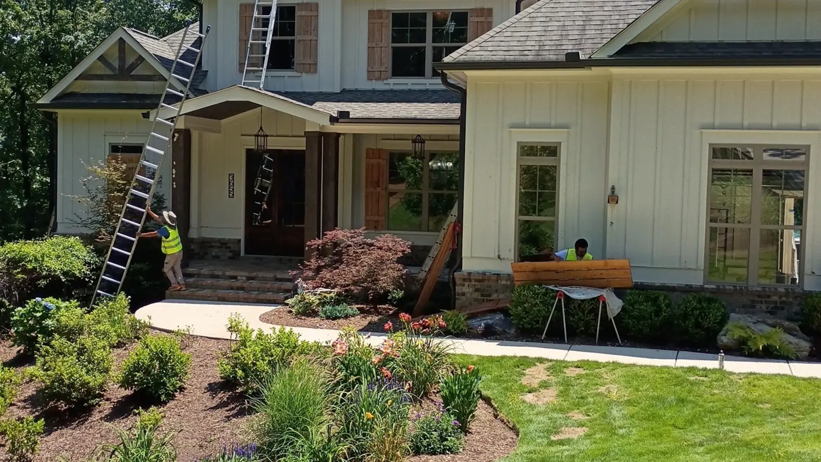 Wheeler Painting crew working on a two-story craftsman home exterior in North Georgia