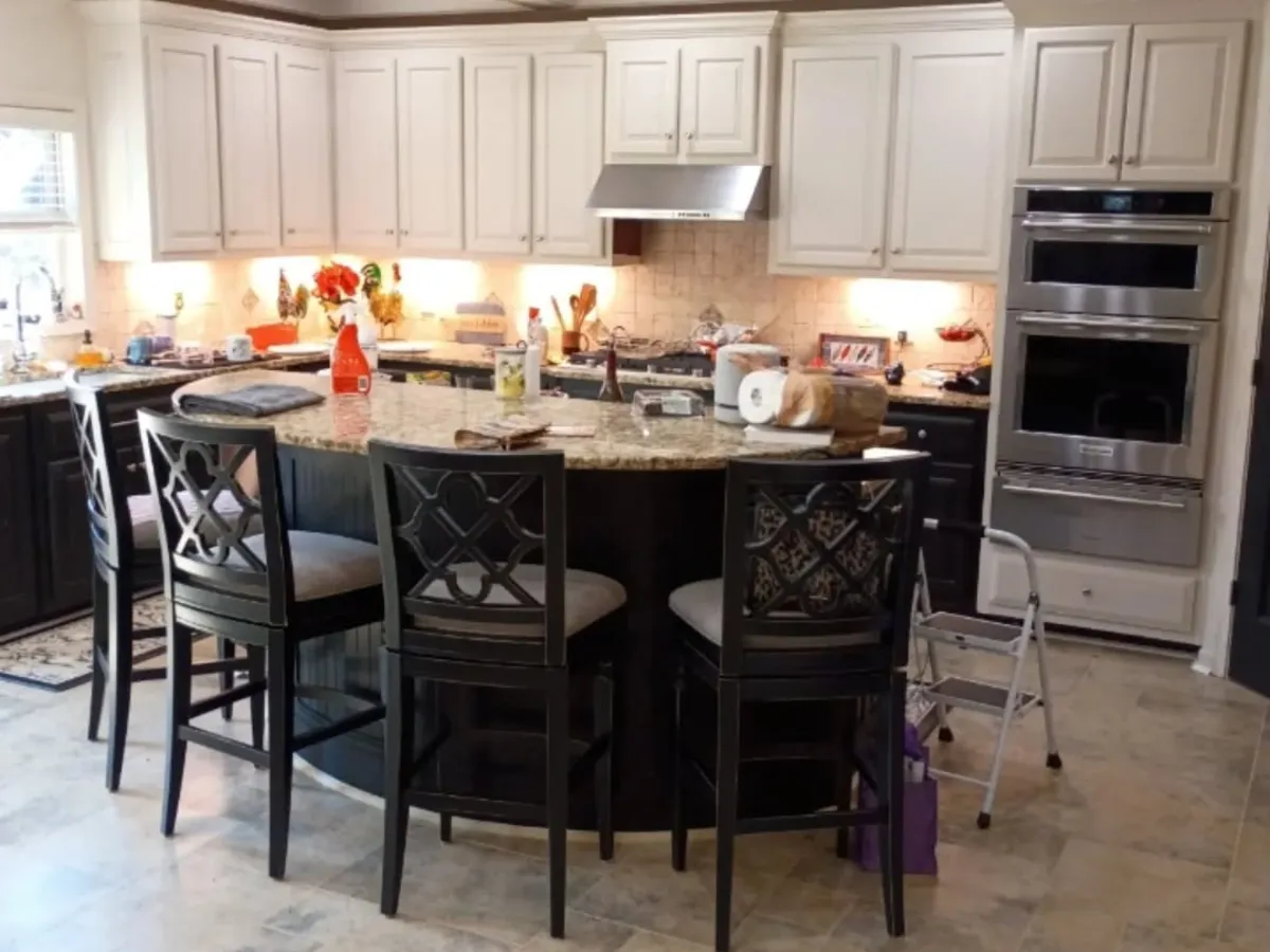 Two-tone kitchen cabinets: cream uppers and dark island after refinishing